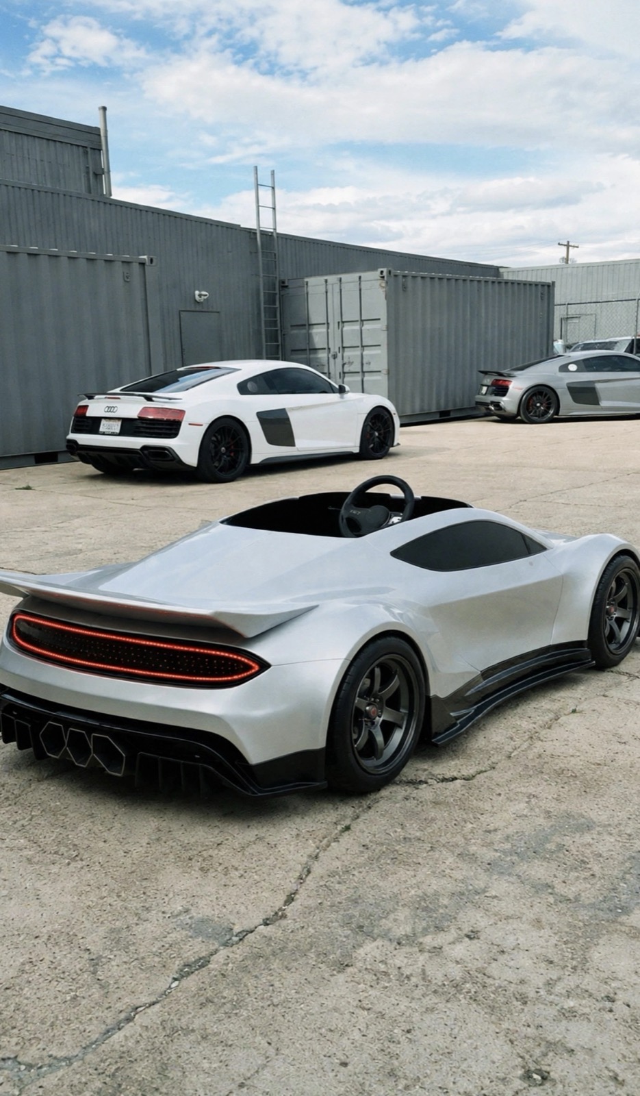 GENOS R1 parked beside full-scale supercars